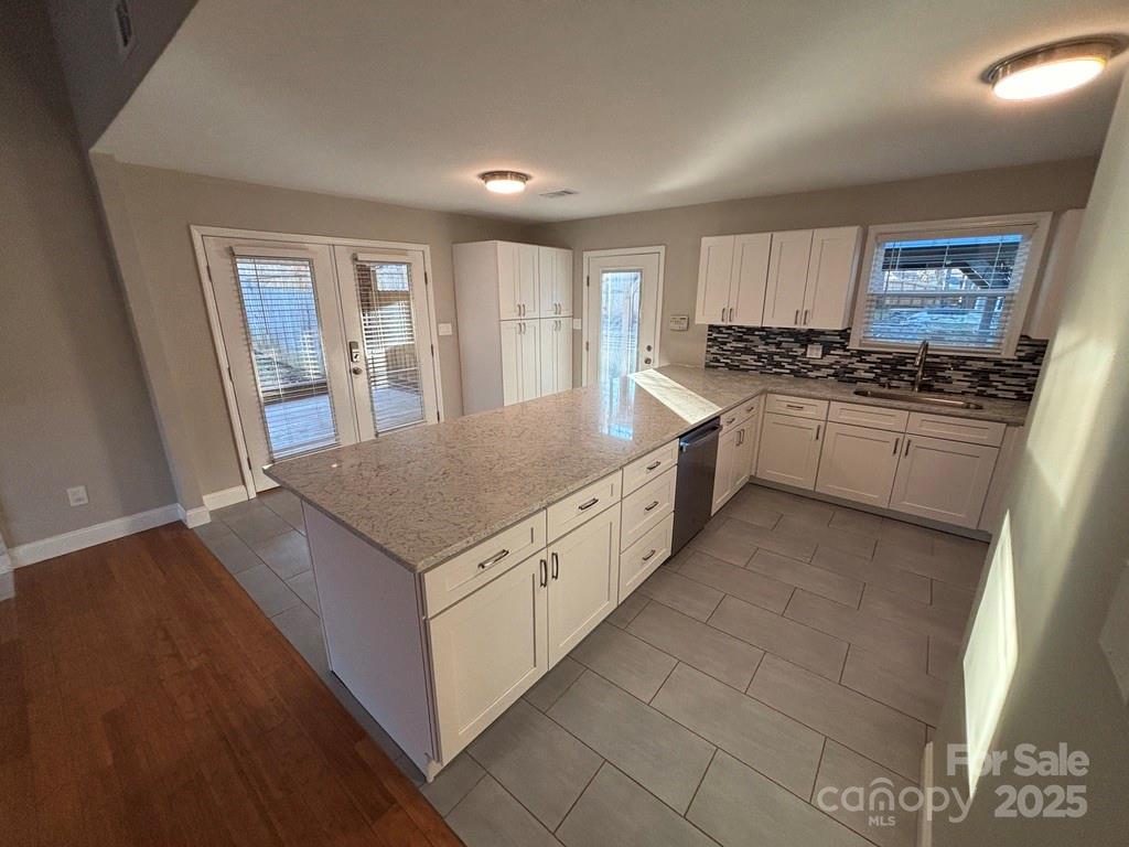 2411 Sutters Road Concord, NC 28027 - Photo 7 of 27 a large kitchen with stainless steel appliances granite countertop a stove and a sink