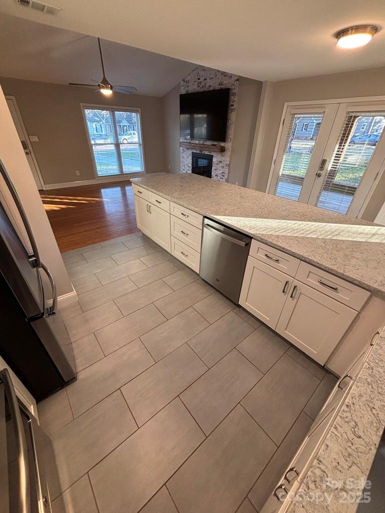 2411 Sutters Road Concord, NC 28027 - Photo 8 of 27 a kitchen with granite countertop a sink a stove top oven and cabinetry