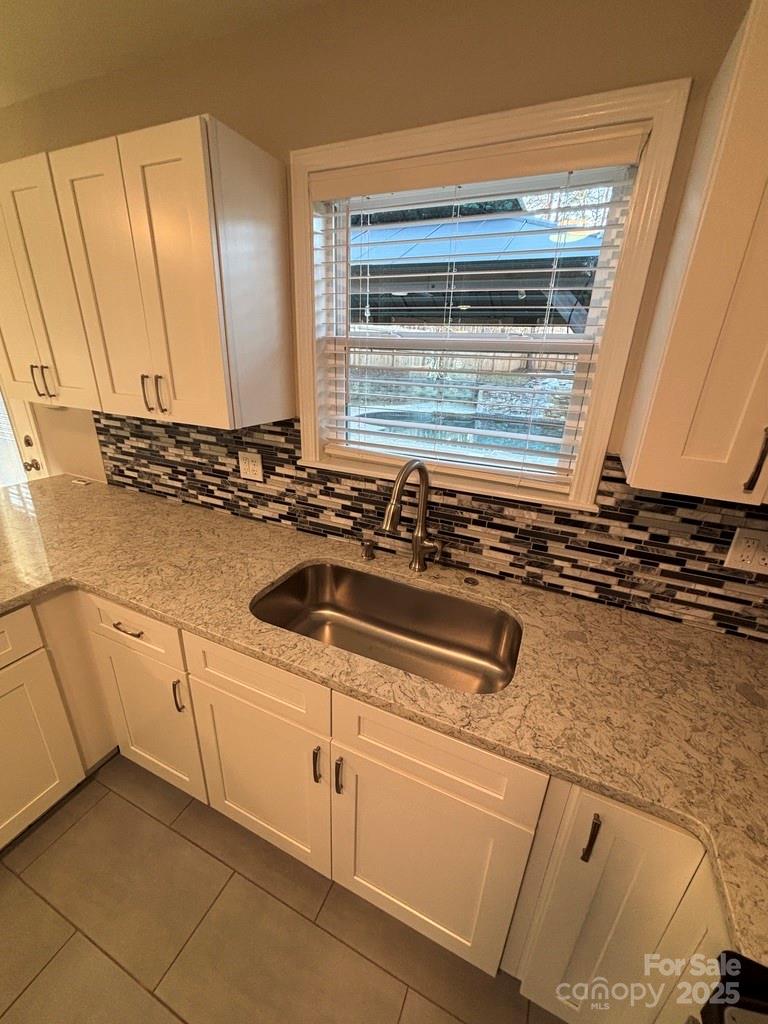 2411 Sutters Road Concord, NC 28027 - Photo 10 of 27 a kitchen with a sink and cabinets
