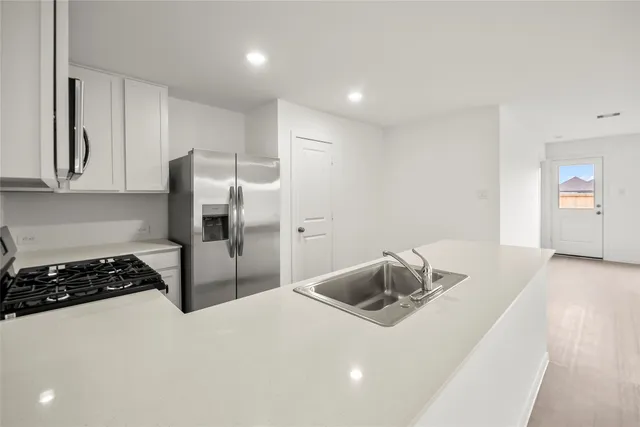 an empty room with windows and cabinet