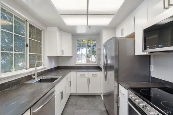 a kitchen with a sink stove and refrigerator