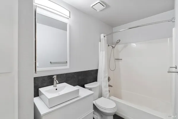 a bathroom with a sink a toilet and a shower