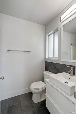 a white toilet sitting next to a bathroom sink