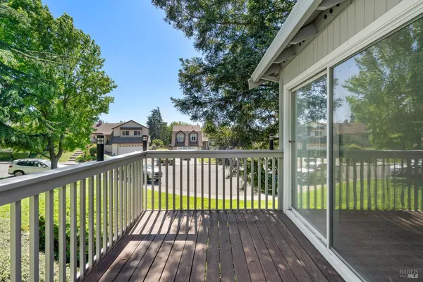 a view of balcony with wooden floor