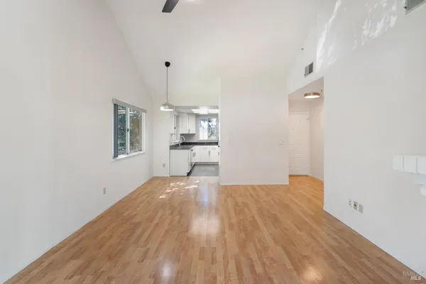 a view of a kitchen with wooden floor and a kitchen