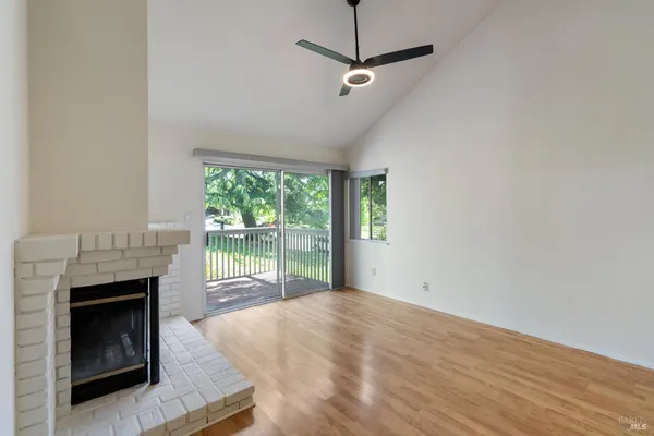 a view of empty room with fireplace and fan