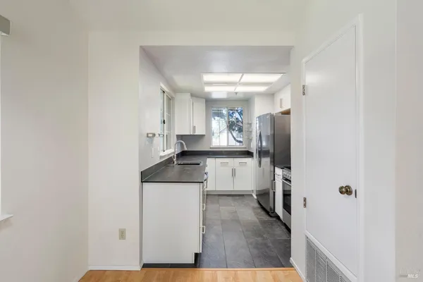 a kitchen with a sink and refrigerator
