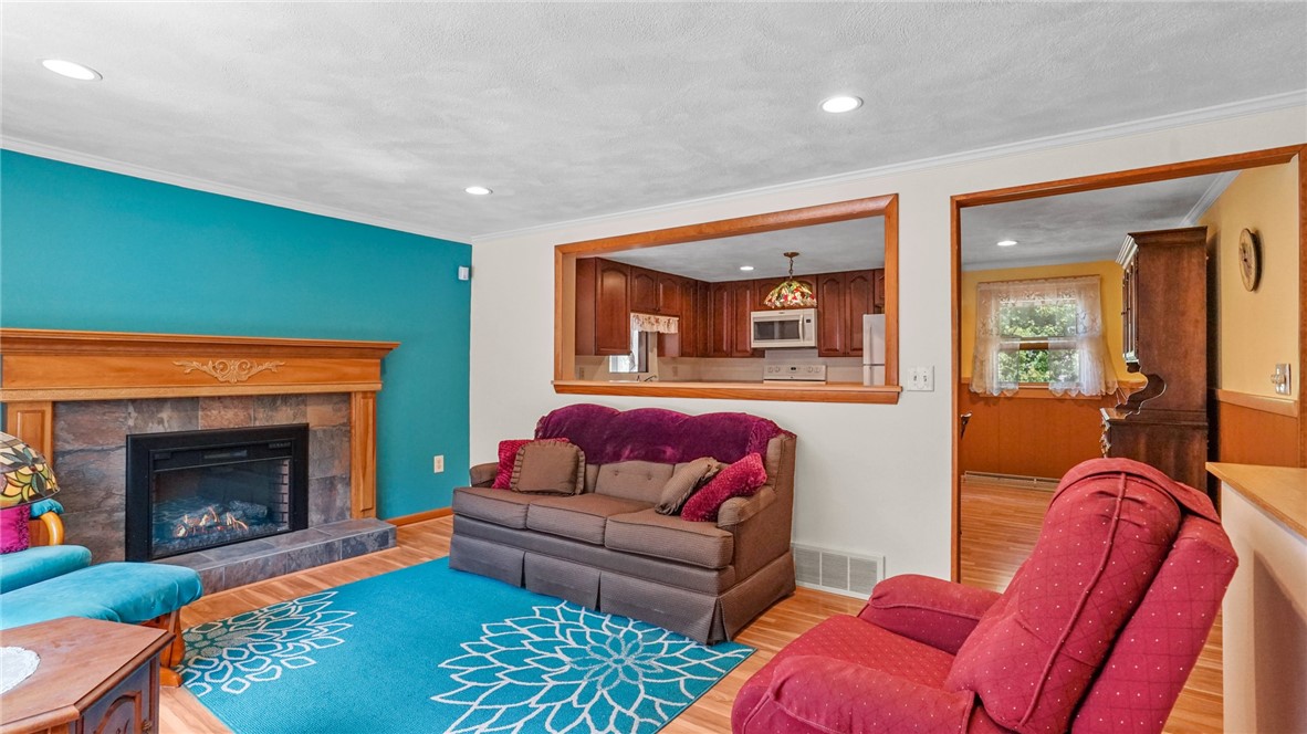 44 Morin Street Woonsocket, RI 02895 - Photo 9 of 36 New electric fireplace with tile surround and wood mantle
