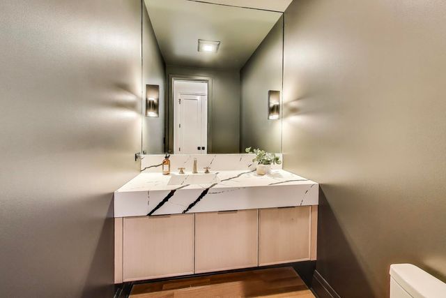 a view of staircase with lots of frames on wall and a window