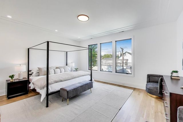 a bedroom with a bed dresser and a window