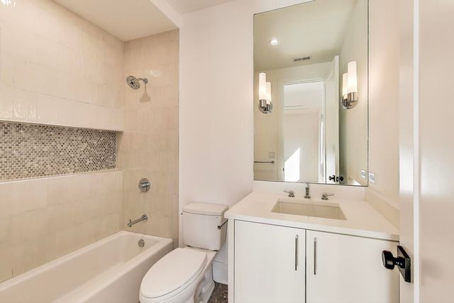 a view of a kitchen with washing machine and a sink
