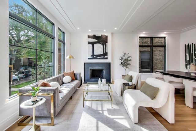 a living room with furniture and a floor to ceiling window