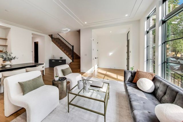 a dining room with furniture and wooden floor