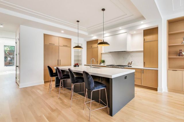 a kitchen with stainless steel appliances a stove a sink and a refrigerator
