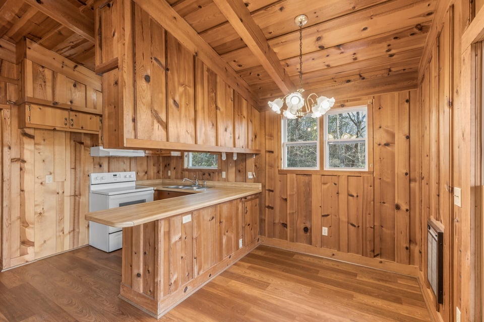 795 Buck Falls Road Highlands, NC 28741 - Photo 10 of 39 Open living and dining area with solid wood interior and warm cabin character