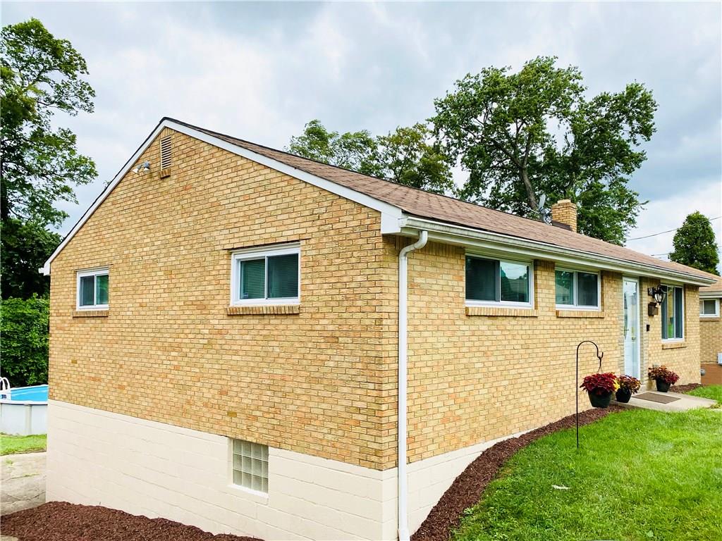 543 Grove Road Verona, PA 15147 - Photo 22 of 24 Southeasterly side of 543 Grove Road. Driveway wraps around this side of the house and leads to the attached single-car garage. Entry to the finished full-basement through the garage. Above ground pool located in the backyard is included in the sale.