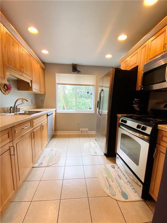 543 Grove Road Verona, PA 15147 - Photo 5 of 24 View of kitchen from living room. Window looks out onto the back yard and above ground pool. Stainless steal oven, stovetop, microwave, dishwasher and refrigerator are all included in the sale.