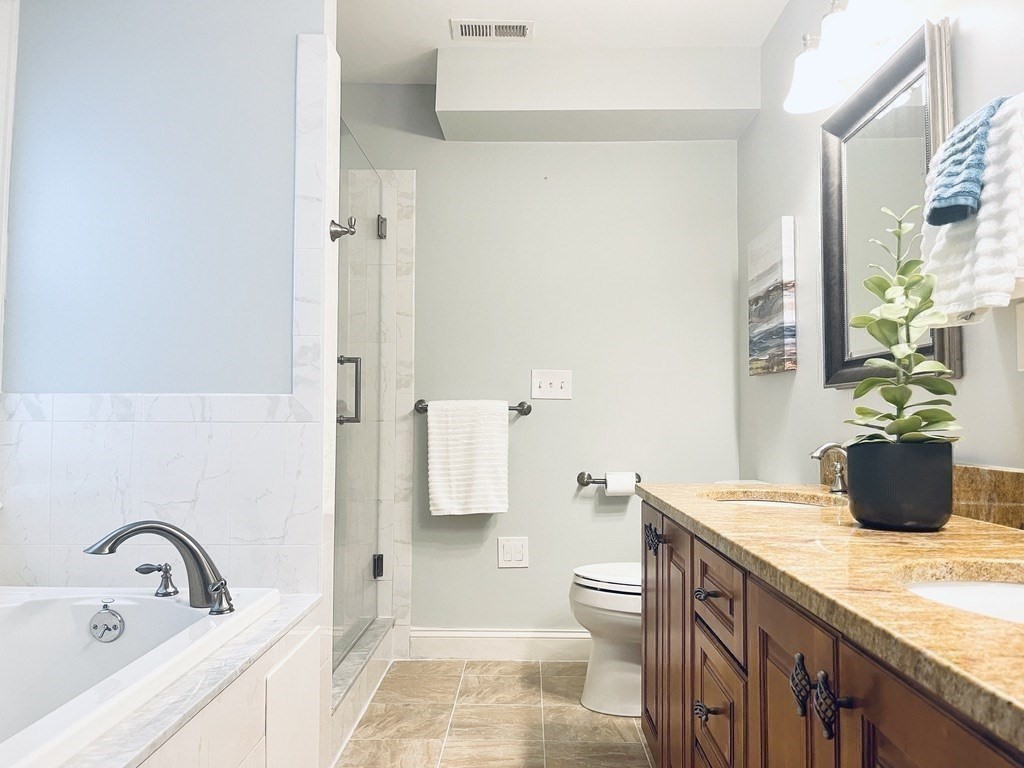 8 Cragmore Road, Unit 8 Newton, MA 02464 - Photo 12 of 27 a bathroom with a sink a toilet and shower