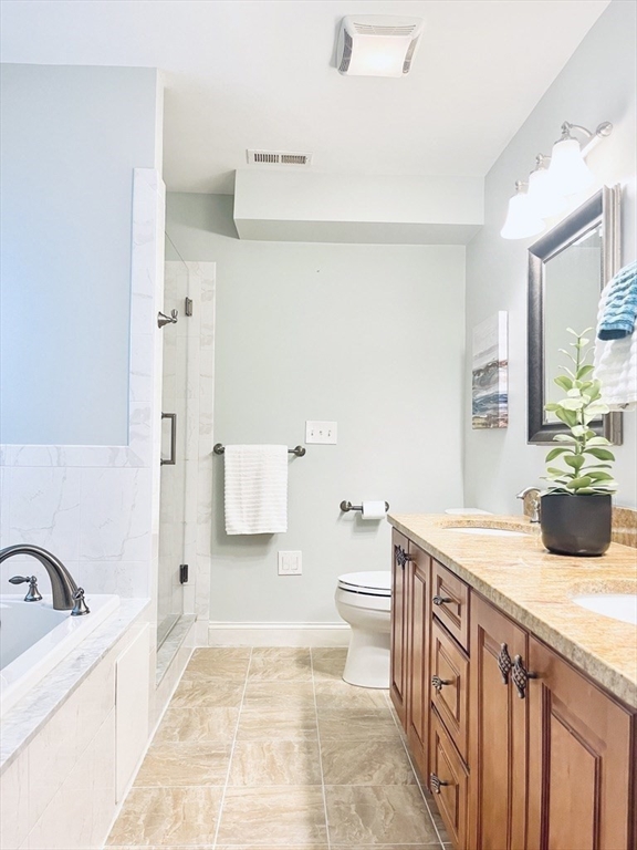8 Cragmore Road, Unit 8 Newton, MA 02464 - Photo 13 of 27 a bathroom with a sink a bathtub and a toilet