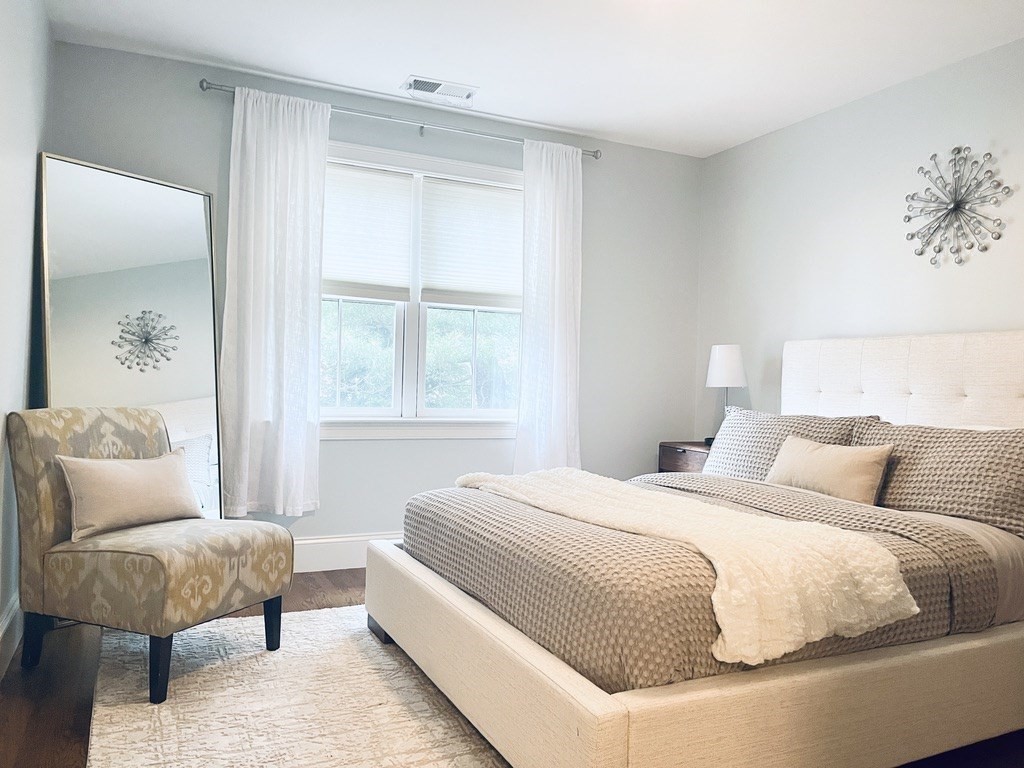 8 Cragmore Road, Unit 8 Newton, MA 02464 - Photo 14 of 27 a bedroom with a large bed and a couch