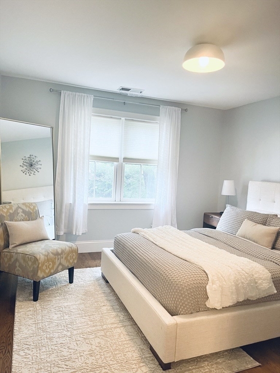 8 Cragmore Road, Unit 8 Newton, MA 02464 - Photo 15 of 27 a bedroom with a large bed and a couch