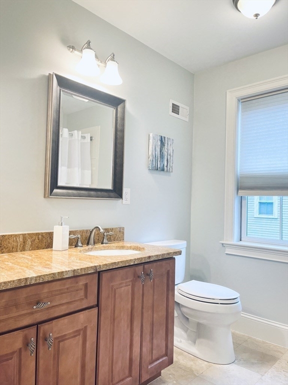 8 Cragmore Road, Unit 8 Newton, MA 02464 - Photo 16 of 27 a bathroom with a toilet sink and mirror
