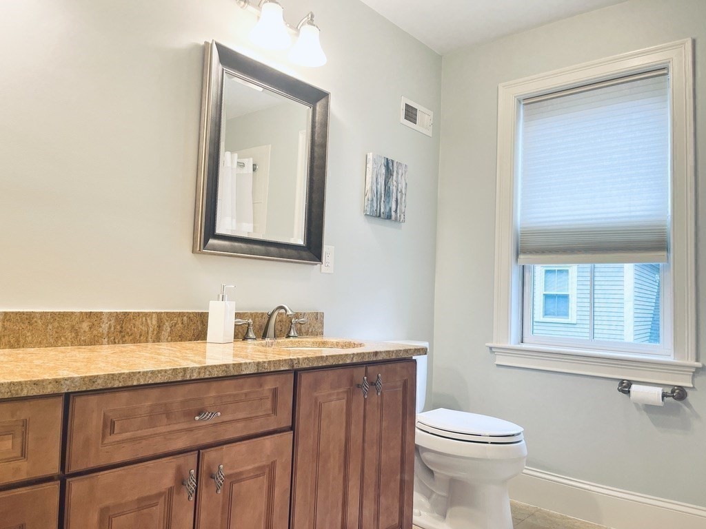 8 Cragmore Road, Unit 8 Newton, MA 02464 - Photo 17 of 27 a bathroom with a toilet sink and mirror