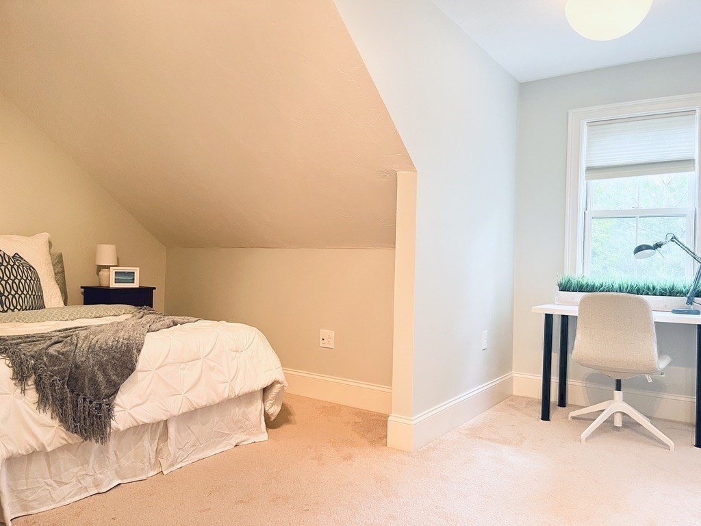8 Cragmore Road, Unit 8 Newton, MA 02464 - Photo 20 of 27 a bedroom with a bed and a chair