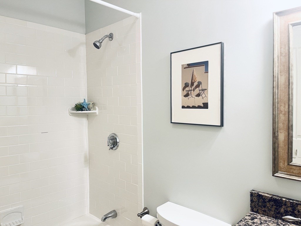 8 Cragmore Road, Unit 8 Newton, MA 02464 - Photo 23 of 27 a white toilet sitting next to a bathroom sink