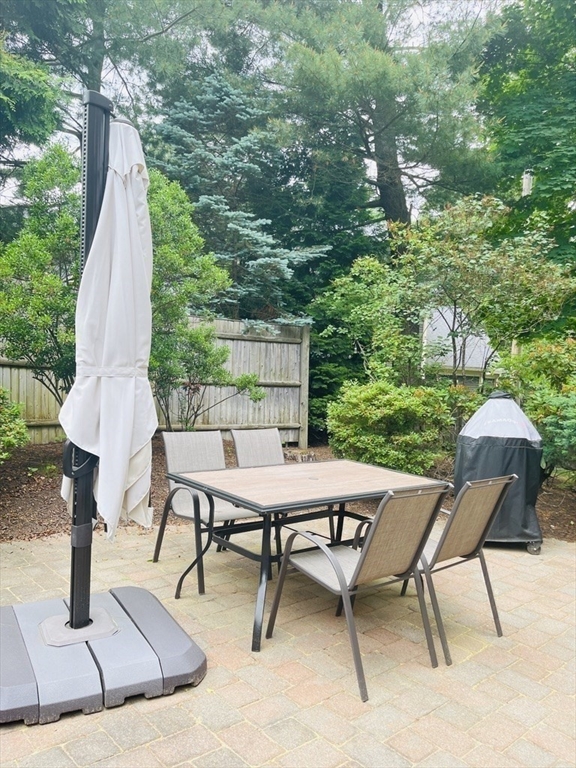 8 Cragmore Road, Unit 8 Newton, MA 02464 - Photo 24 of 27 a view of a backyard with furniture and a slide