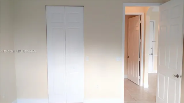 a view of a livingroom with furniture mirror and a chandelier