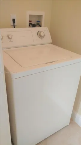 a living room with large window and a chandelier