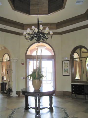a front view of a house with wooden floor and furniture