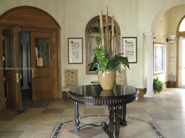 an empty room with a fireplace and wooden floor