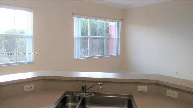 a kitchen with a sink cabinets and window