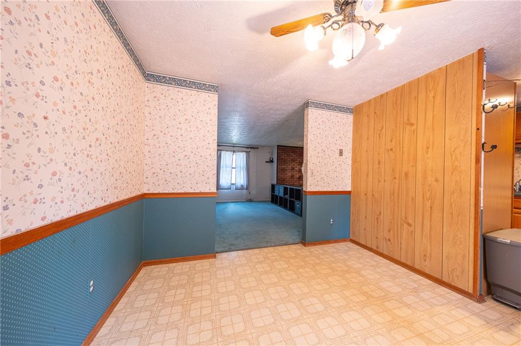 1310 Greenhill Rd Extension Pittsburgh, PA 15209 - Photo 12 of 39 a bedroom with a bed and a chandelier