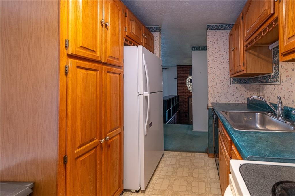 1310 Greenhill Rd Extension Pittsburgh, PA 15209 - Photo 15 of 39 a kitchen with a refrigerator and a sink