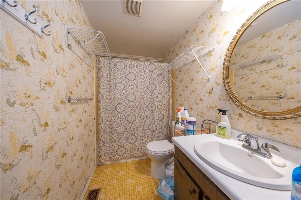 1310 Greenhill Rd Extension Pittsburgh, PA 15209 - Photo 23 of 39 a bathroom with a sink and a mirror