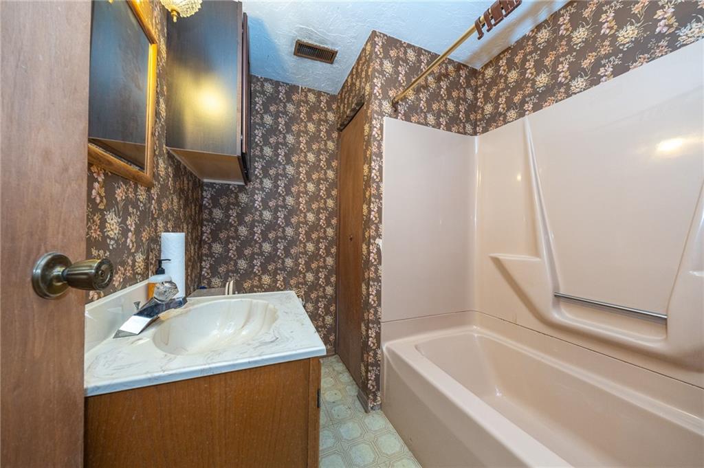 1310 Greenhill Rd Extension Pittsburgh, PA 15209 - Photo 26 of 39 a bathroom with a sink and a mirror