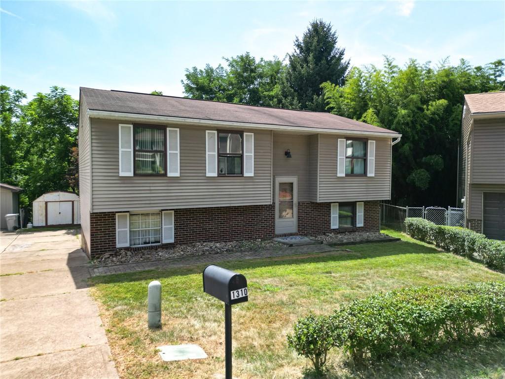 1310 Greenhill Rd Extension Pittsburgh, PA 15209 - Photo 37 of 39 a front view of house with yard and trees in the background