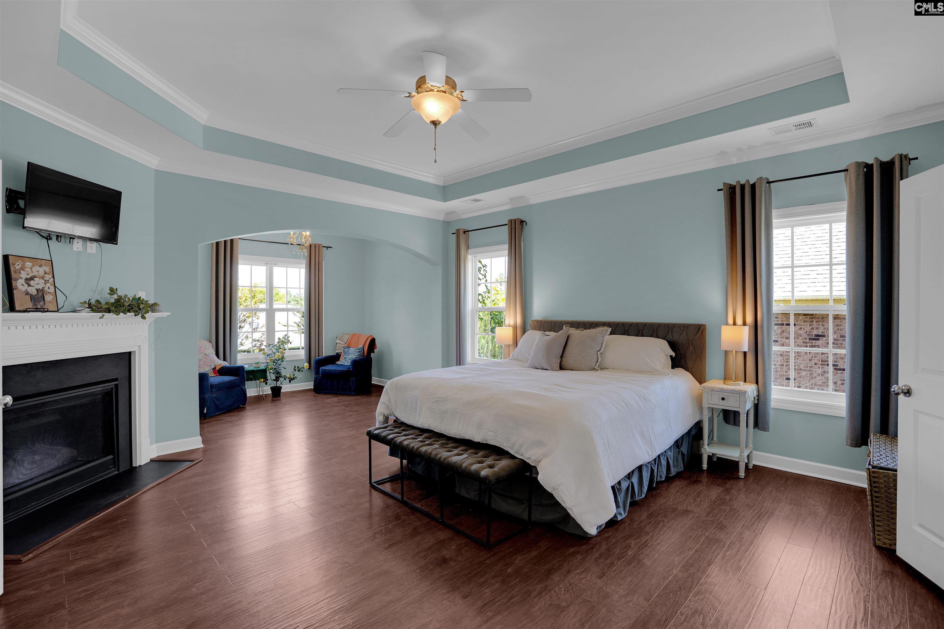 321 Asa Rose Lexington, SC 29072 - Photo 23 of 52 a spacious bedroom with a bed and a chandelier