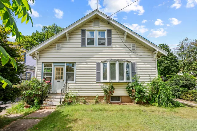 a front view of a house with a yard
