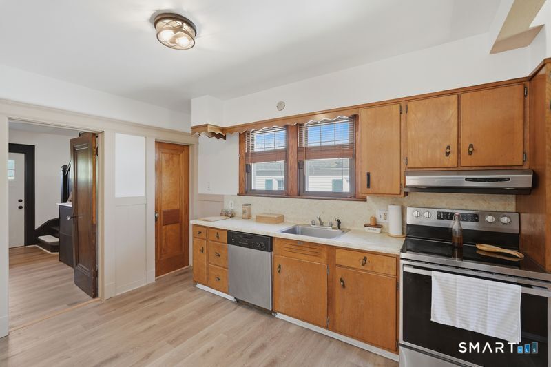 443 Highland Avenue Waterbury, CT 06708 - Photo 11 of 24 a kitchen with stainless steel appliances granite countertop a stove and a sink