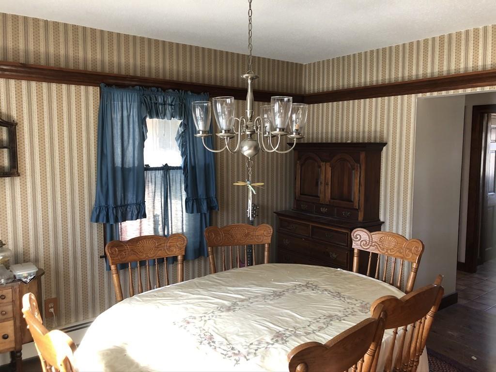 25 Long Boat Road Bourne, MA 02532 - Photo 8 of 23 a view of a dining room with furniture and chandelier