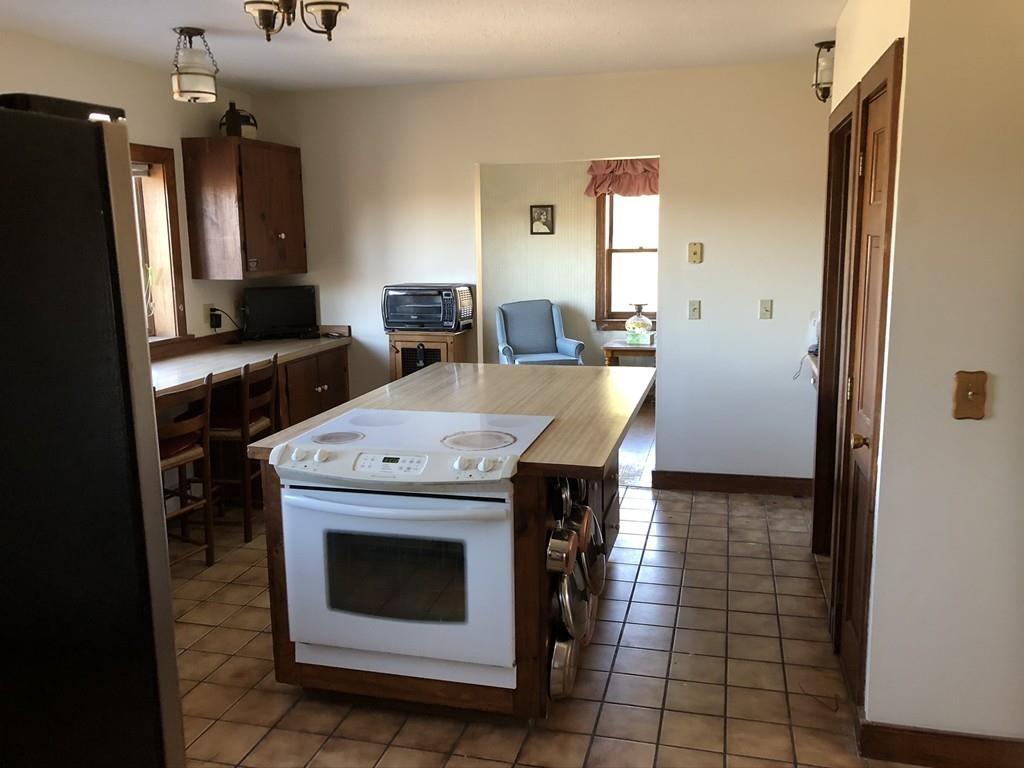 25 Long Boat Road Bourne, MA 02532 - Photo 10 of 23 a kitchen with a stove a refrigerator and a sink