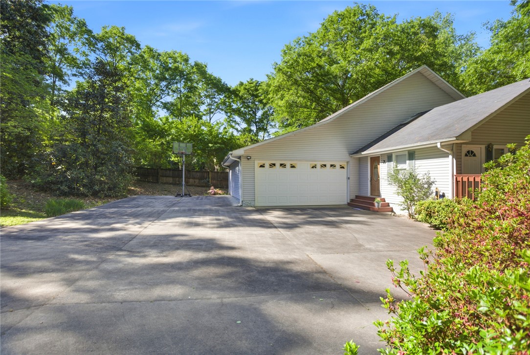 110 Snug Harbor Road Seneca, SC 29678 - Photo 1 of 37 This residence features a convenient attached garage and an inviting entry, all surrounded by mature landscaping.