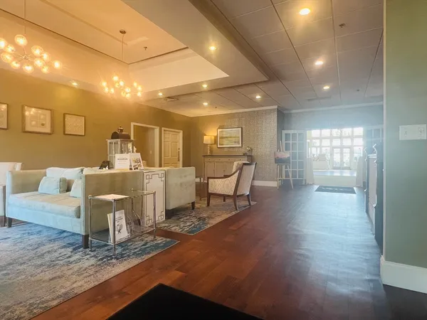 a living room with furniture and a wooden floor