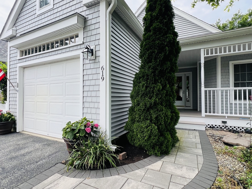 619 White Cliffs Drive, Unit 619 Plymouth, MA 02360 - Photo 16 of 42 a potted plant sitting on the side of a building