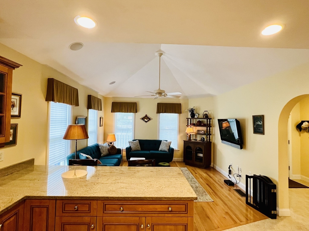 619 White Cliffs Drive, Unit 619 Plymouth, MA 02360 - Photo 19 of 42 a living room with stainless steel appliances kitchen island granite countertop furniture and a view of kitchen