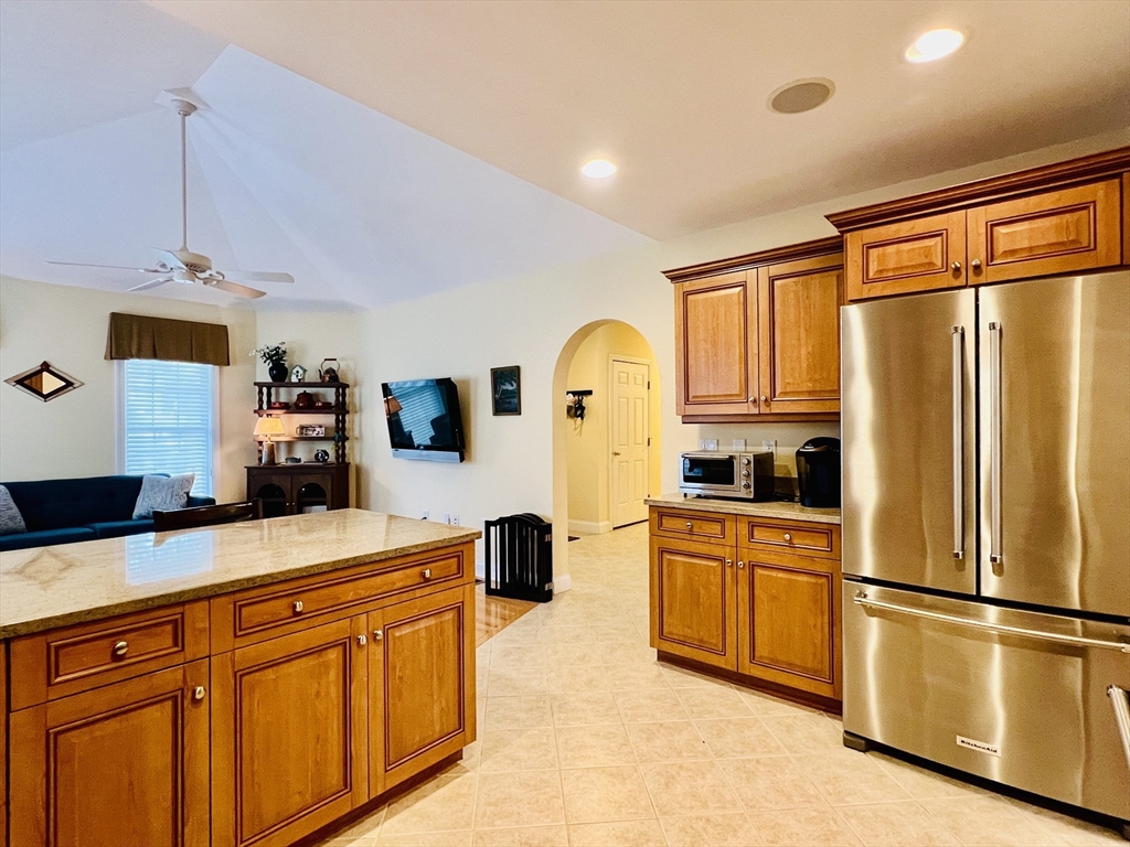 619 White Cliffs Drive, Unit 619 Plymouth, MA 02360 - Photo 20 of 42 a kitchen with stainless steel appliances granite countertop a refrigerator a stove and a sink with cabinets